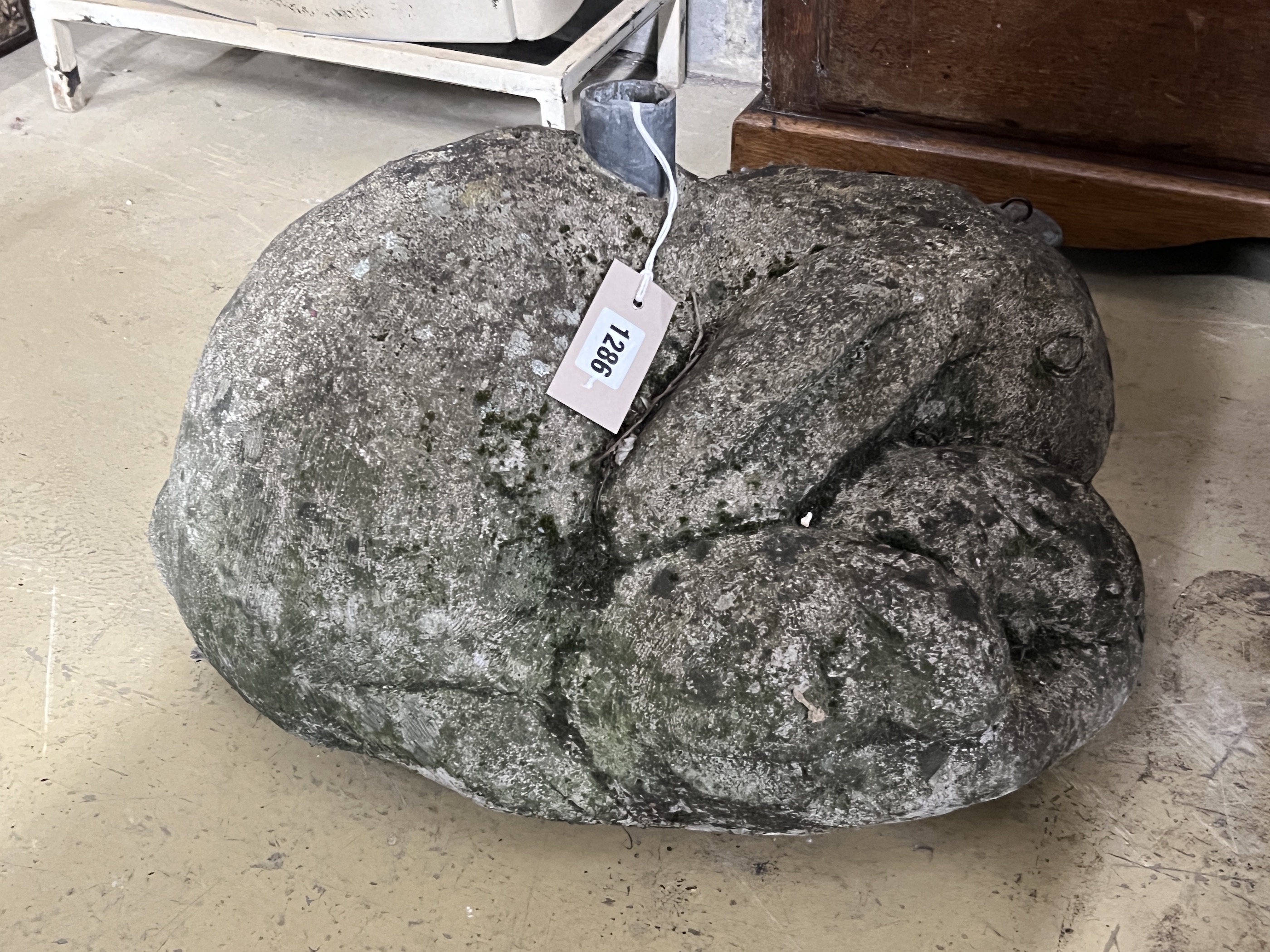 A reconstituted stone rabbit garden ornament, possibly a parasol base, width 48cm, height 30cm